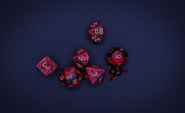 Burgundy Dungeons and Dragons dice on blue background