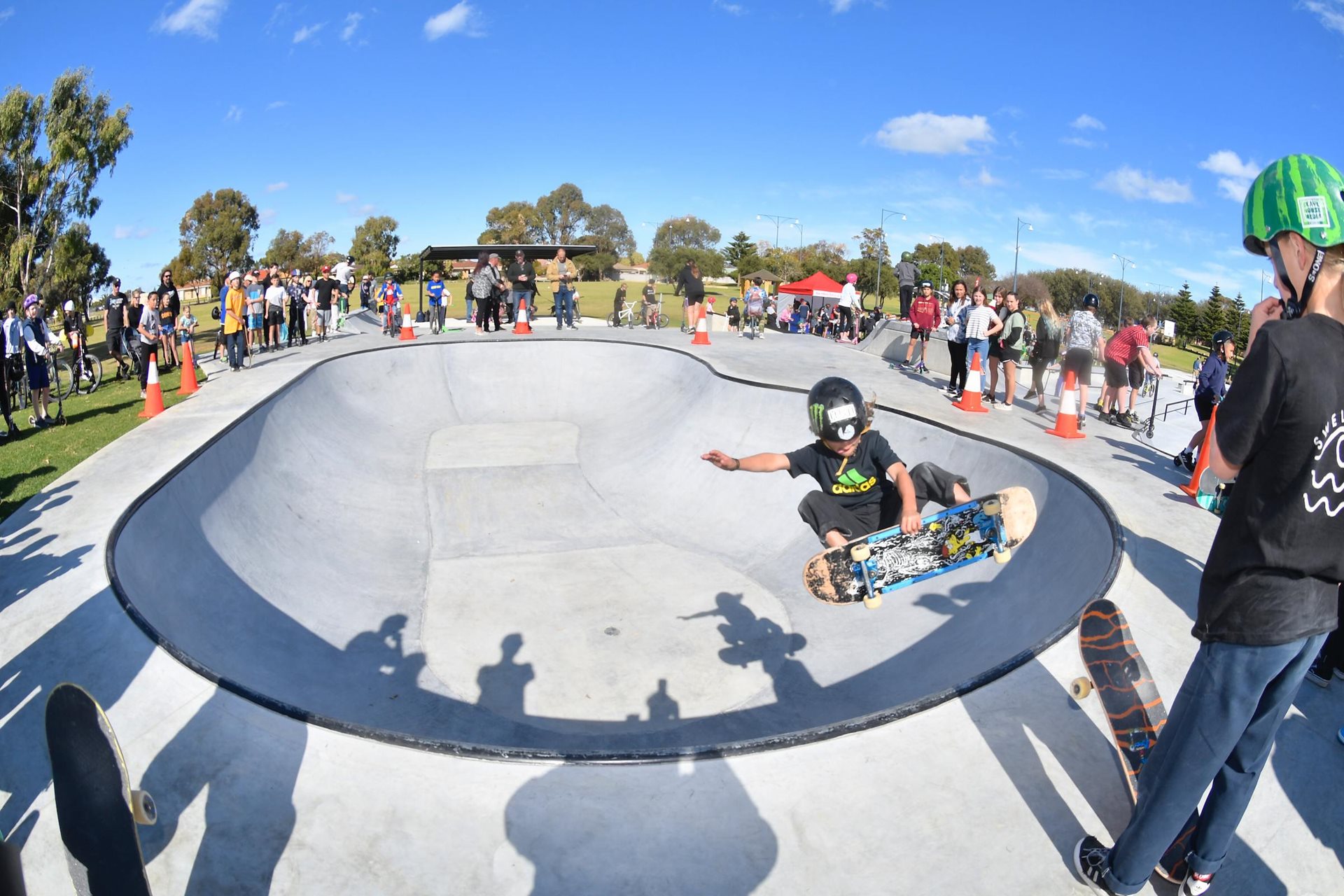 Skateboarder performing at a competition in a bowl.