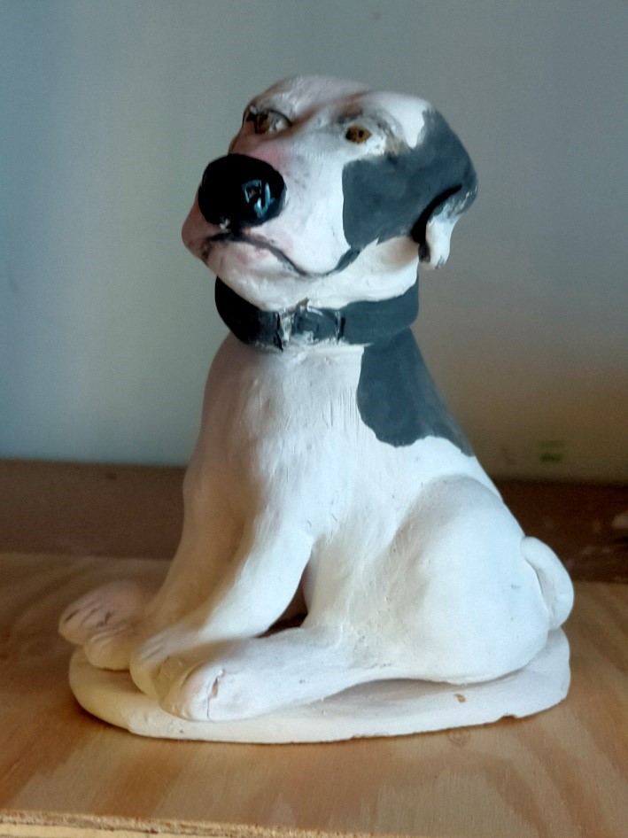 Ceramic sculpture of a dog.