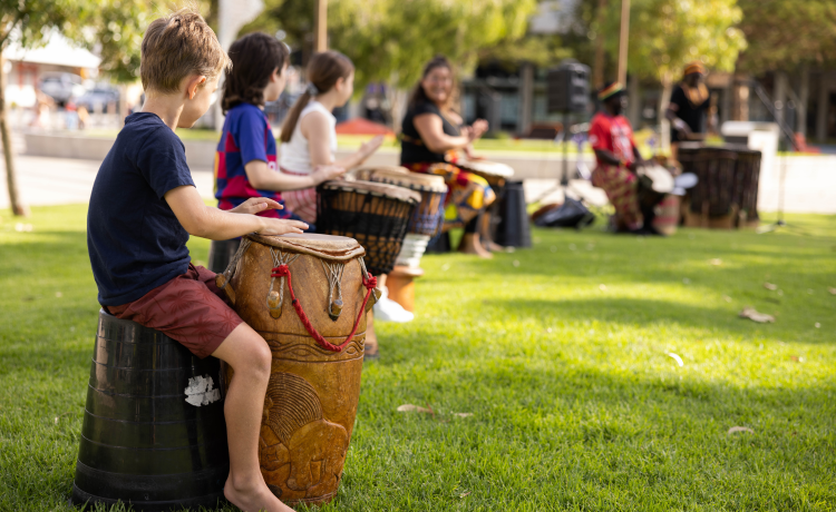 Children participating in a drumming circle.