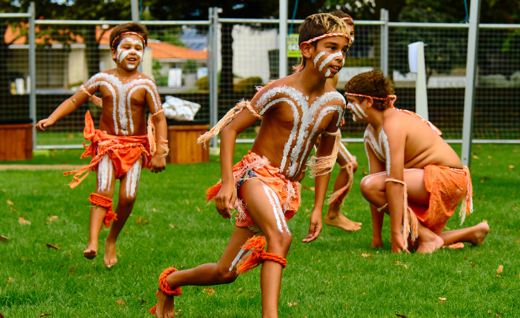 First Nations children in traditional clothes performing a cultural dance