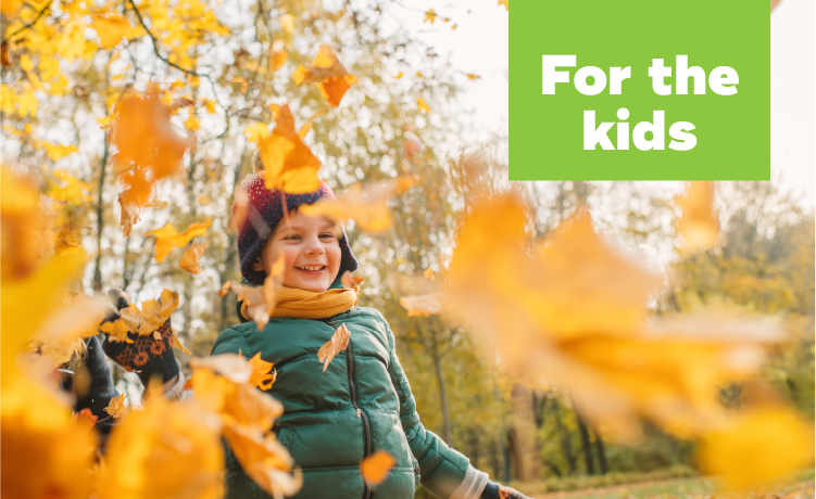 Child among autumn leaves.