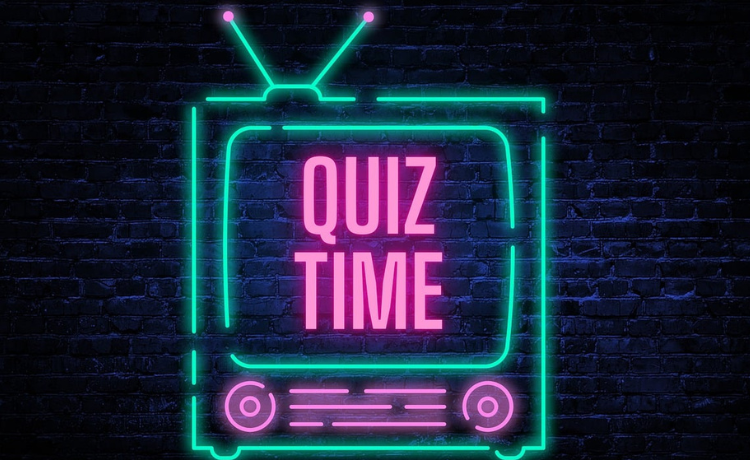 A neon lit television with the words Quiz Time in pink