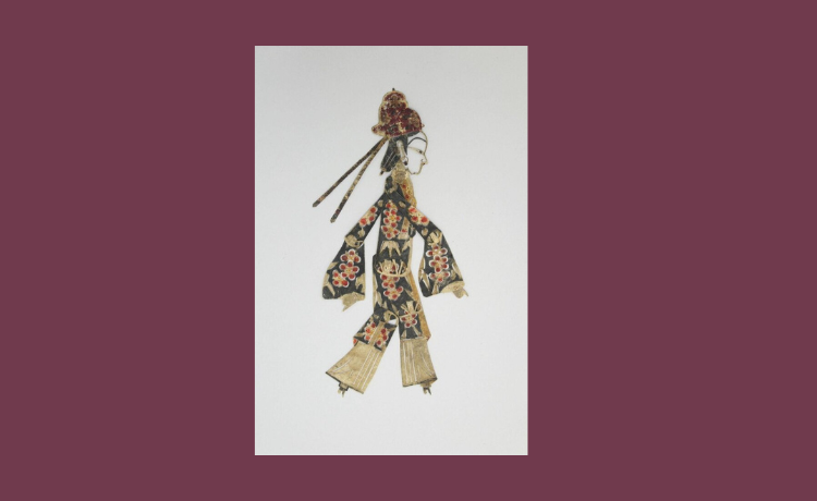 a chinese shadow puppet against a maroon background
