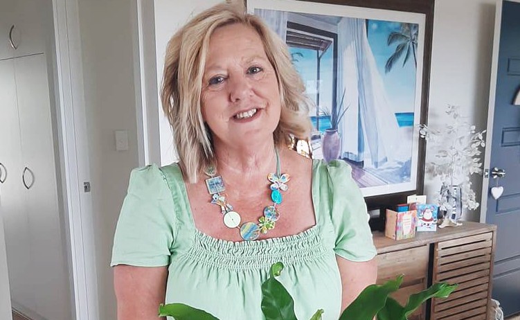 Image of a woman smiling with decorative necklace