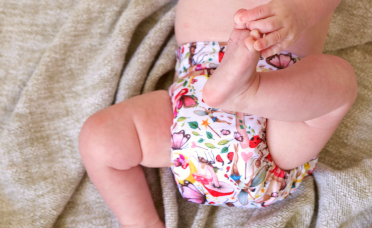 Baby in cloth nappy on blanket