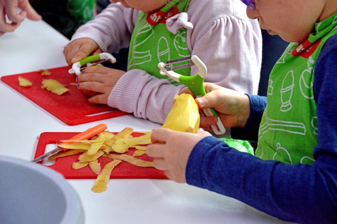 Child peeling a potato.