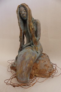 Sculpture of a mermaid sitting on a rock