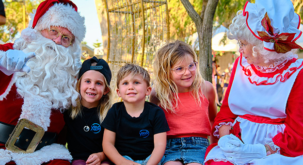 Santa and Mrs Claus with children.