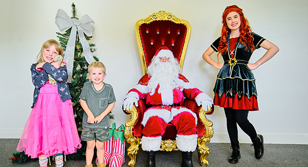 Santa with children and an elf helper.