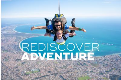 Two people tandem skydiving over Rockingham coast