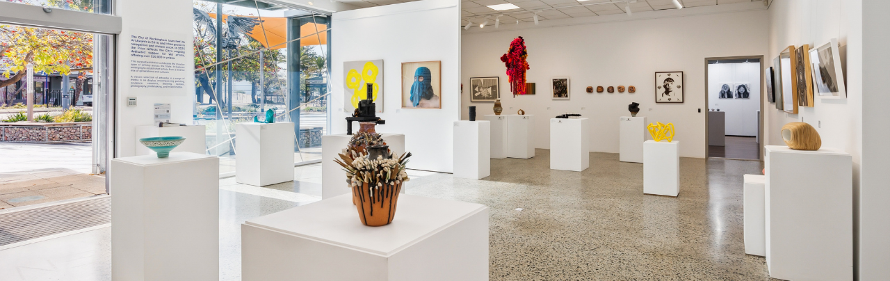 Interior of the Rockingham Arts Centre with artworks on display.