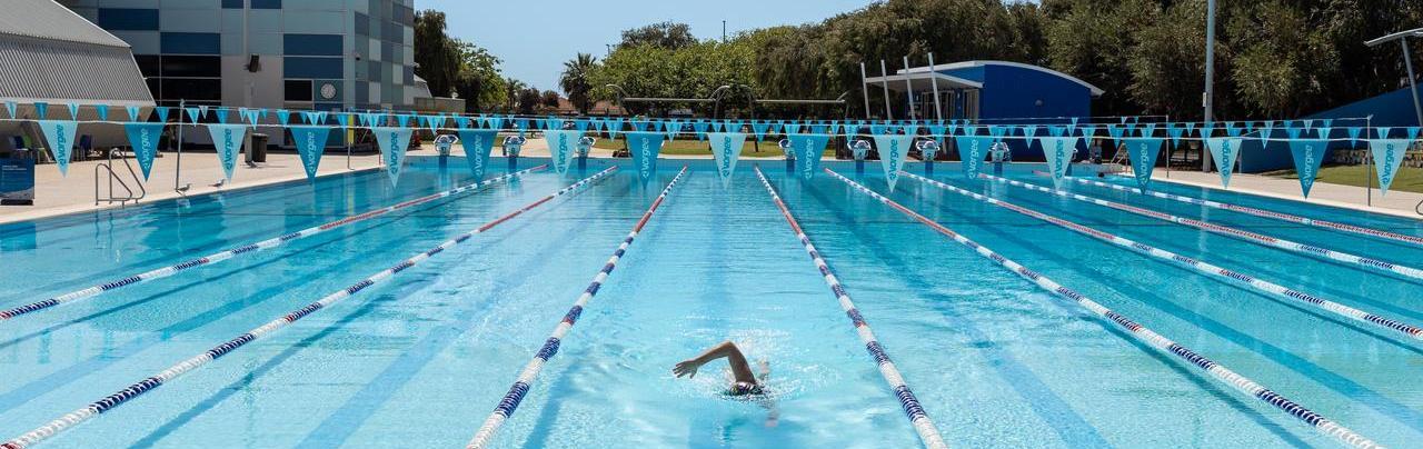 Swimmer doing laps in the outdoor Aqua Jetty pool.