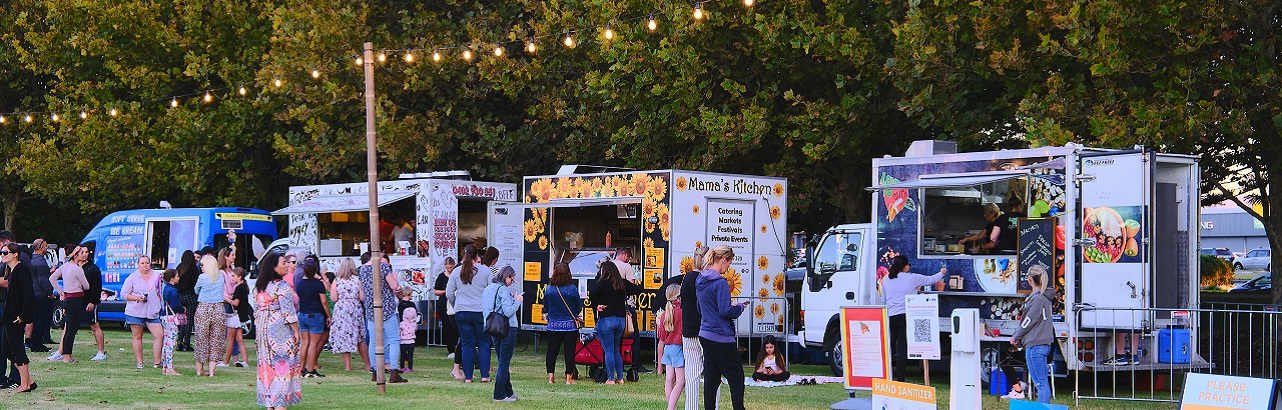 A row of food trucks at community event.