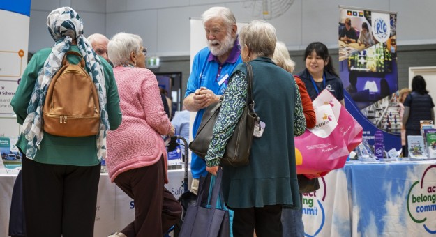 Attendees speaking with stallholders at the Seniors and Carers Expo 2025