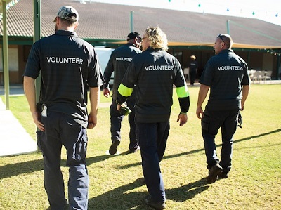 Group of volunteers outside with their volunteer shirts