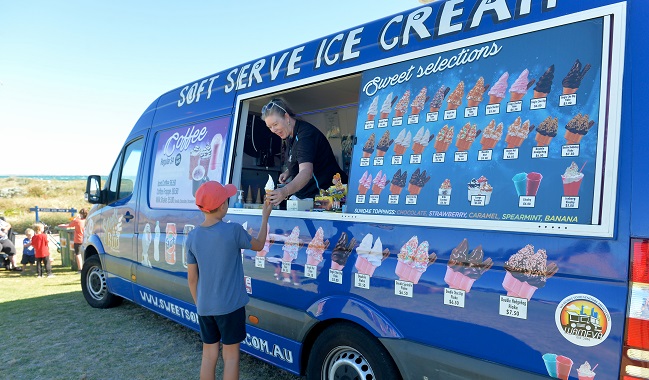 An ice cream truck serving a customer. 