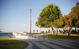 a group of people walking on a walkway