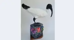 a bird sculpture on a block