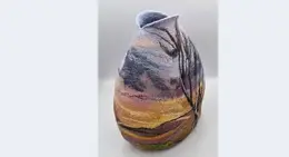 a vase with a landscape on it
