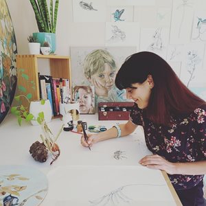 a woman drawing on a paper