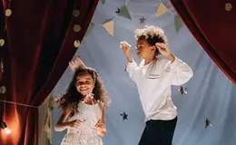 a boy and girl dancing on stage