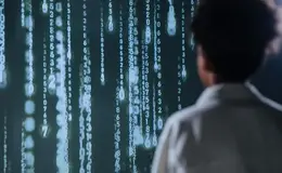 a man looking at a screen with numbers