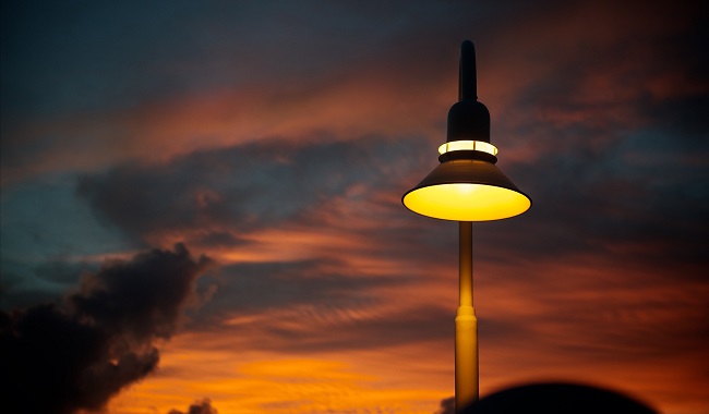 a light pole with a yellow light in the middle