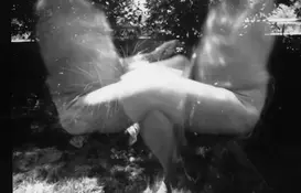 a blurry image of a couple of people sitting outside
