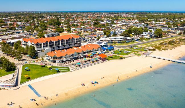 a beach with buildings and a body of water
