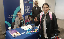 a group of people standing next to a table