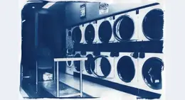 a group of washing machines in a laundry room