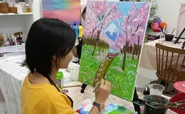 a woman painting a picture