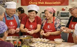a group of women in aprons smiling