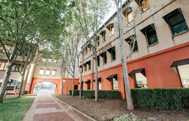 a building with trees and a walkway