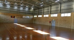 a large indoor gym with a basketball court