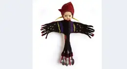 a doll with a hat and spoons