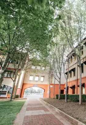 a building with trees and grass