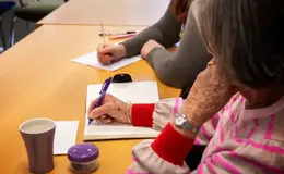 a person writing on a notebook