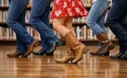 a group of people dancing in a library
