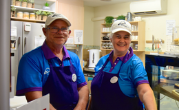 a man and woman wearing matching outfits