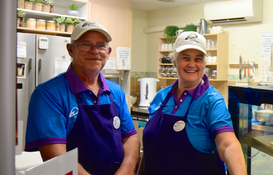 a man and woman wearing matching outfits