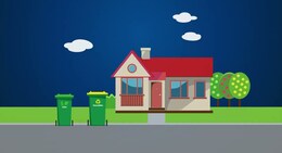 a house with a red roof and two trash cans