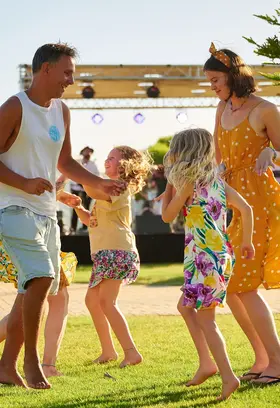 a group of people dancing on grass