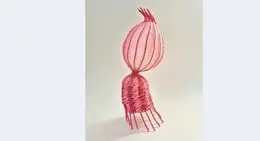 a pink object with a round object on top