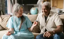 a man and woman sitting on a couch