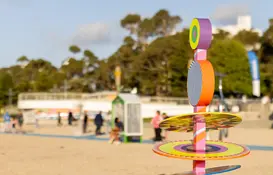 a colorful sculpture on a beach