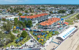 aerial view of a beach with many people and tents
