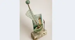 a sculpture of a boat and a flag
