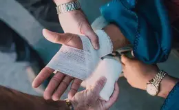 A person receiving first aid being bandaged